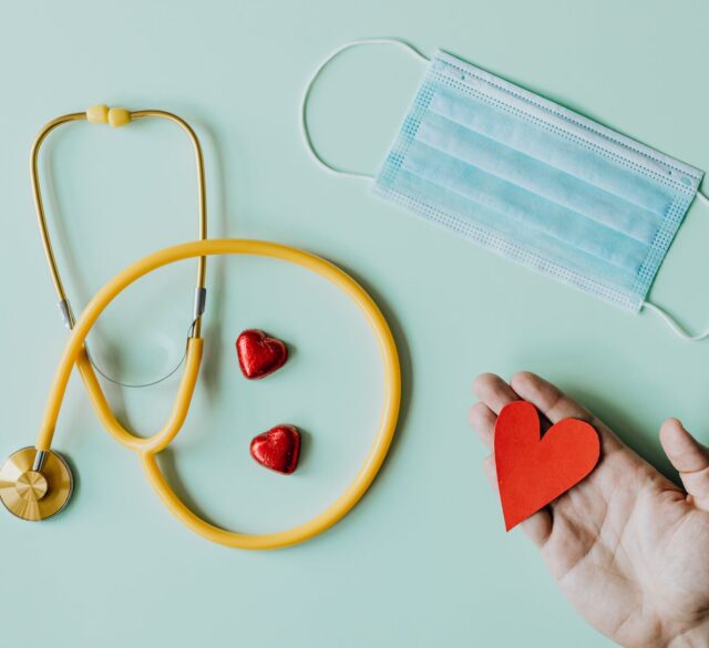 medical stethoscope and mask composed with red foiled chocolate hearts